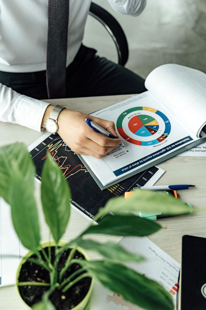 The Art of Drawing Readers In: Your attractive post title goes here Business professional analyzing financial graphs and charts at an office desk with a laptop.